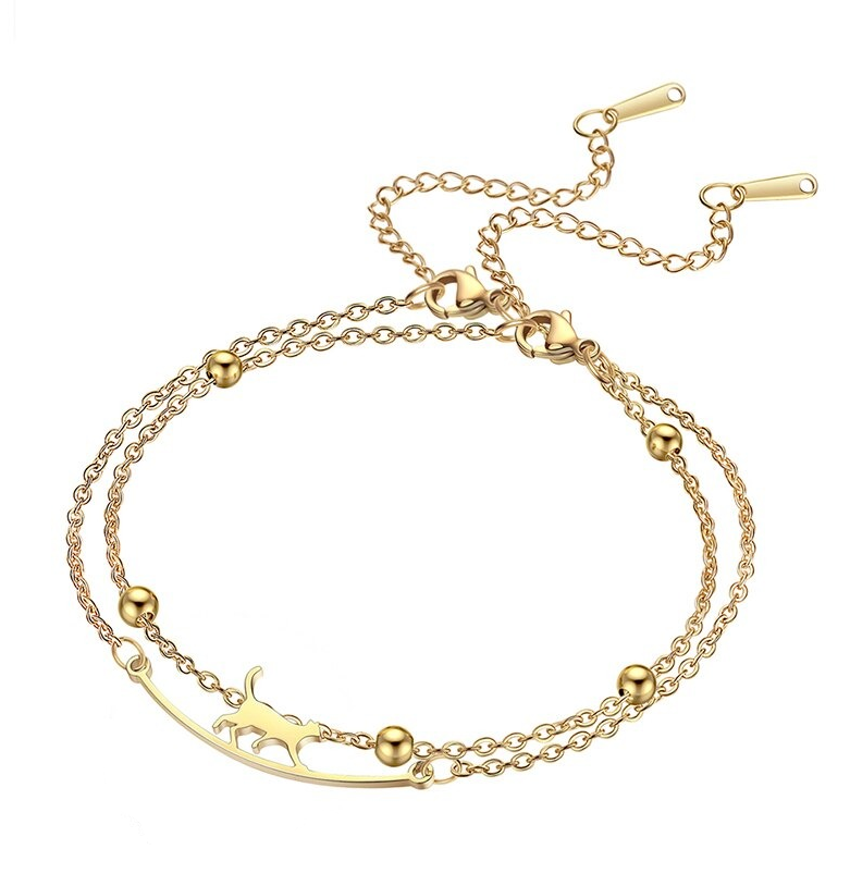 Katten armband goudkleurig in 2 delen. Ene deel heeft een kat die loopt op een randje, de ander heeft balletjes.